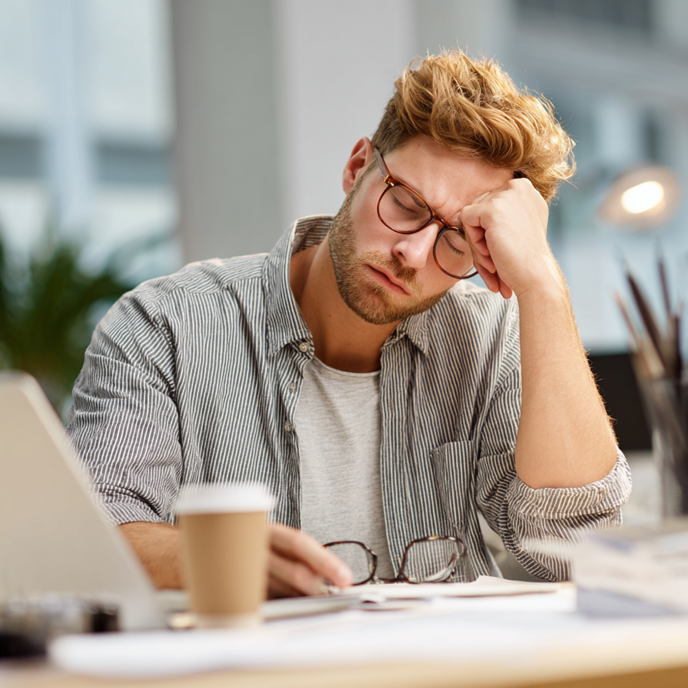 A professional person working and looking fatigued