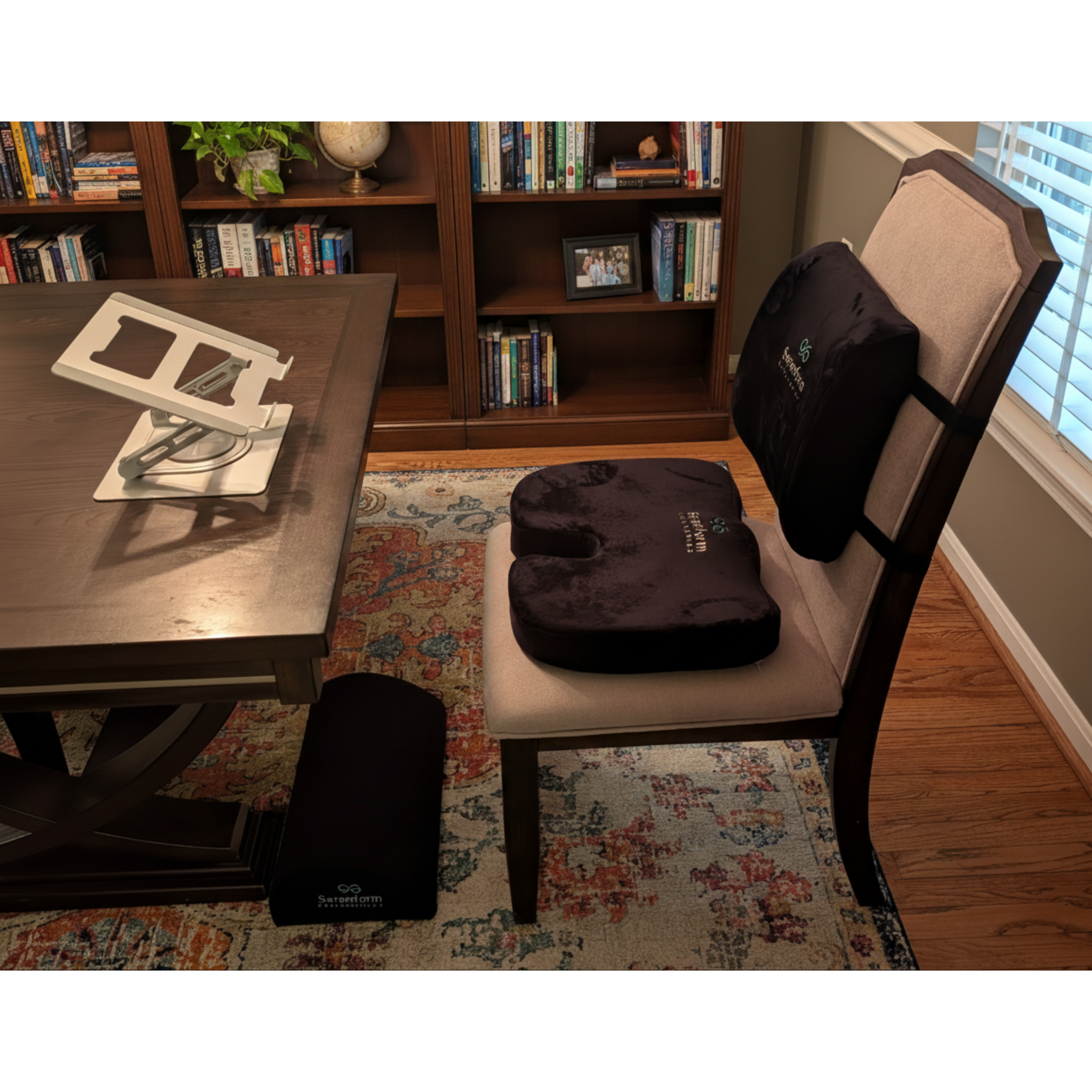 Ergonomic home office setup with lumbar support, seat cushion, footrest, and laptop stand shown in a real workspace for improved comfort and posture