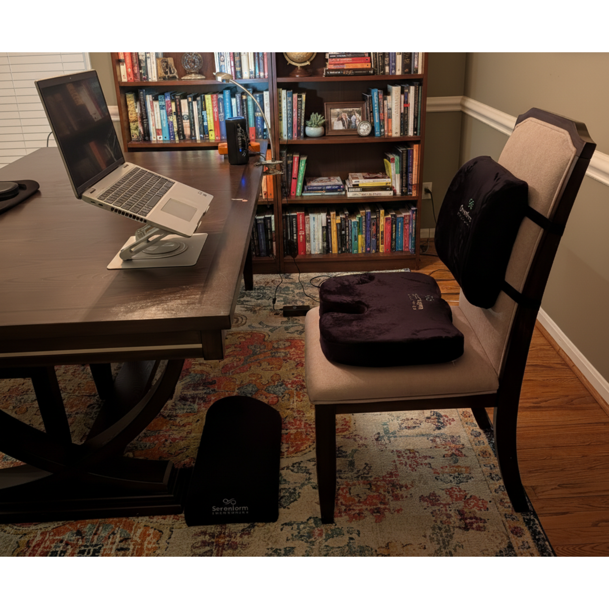 Complete ergonomic workstation setup with a seat cushion, lumbar pillow, footrest, and adjustable laptop stand to support posture and reduce back strain